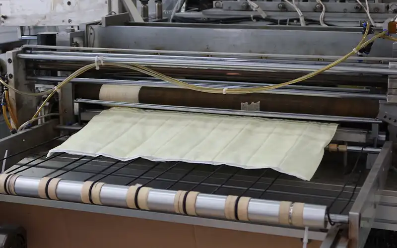 Cleanlink's air filter machine is producing the filter pocket for a pocket filter.